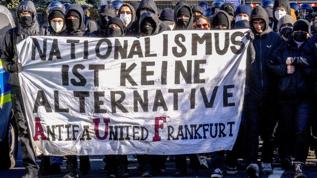 Demonstrators carry a sign reading "nationalism is no alternative" during a protest against an AfD election campaign in Neu Isenburg near Frankfurt, Germany, Saturday, Feb. 1,