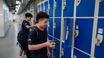 Students store their mobile phones in lockers as they head to class under a new law restricting their use on campus at Porto Seguro School in Sao Paulo, Thursday, Feb. 6, 2025