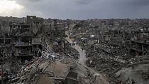 Palestinians walk in the destruction caused by the Israeli air and ground offensive in Jabaliya, Gaza Strip, Thursday, Feb. 6, 2025. 