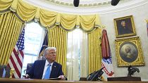 President Donald Trump speaks to reporters after signing executive orders in the Oval Office of the White House
