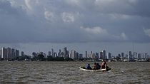 A boat sails on the bay of the Guama River with Belem, Brazil, in the background