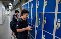 Students store their mobile phones in lockers as they head to class under a new law restricting their use on campus at Porto Seguro School in Sao Paulo, Thursday, Feb. 6, 2025
