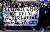 Demonstrators carry a sign reading "nationalism is no alternative" during a protest against an AfD election campaign in Neu Isenburg near Frankfurt, Germany, Saturday, Feb. 1,