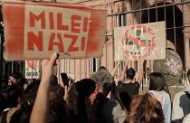 Demonstrators outside the Argentinian government hold up a ‘Milei Nazi’ banner
