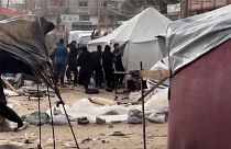 Tents for displaced people getting blown away by strong winds, displaced people tying their tent with ropes 