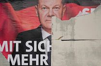 A damaged election poster showing German Chancellor Olaf Scholz is displayed on a road in Wernigerode, 26 January 2025