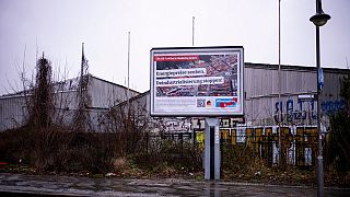 An election campaign poster of Germany's far-right party AfD, Alternative for Germany, reading: 'Reduce energy prices, stop deindustrialization' stand at a road in Berlin.