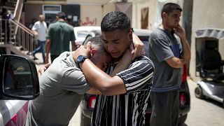 Palestinians mourn relatives killed in the Israeli bombardment of the Gaza Strip, at a hospital morgue in Deir al-Balah.