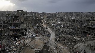 Palestinians walk in the destruction caused by the Israeli air and ground offensive in Jabaliya, Gaza Strip, Thursday, Feb. 6, 2025. 