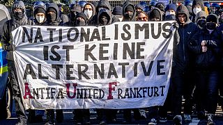 Demonstrators carry a sign reading "nationalism is no alternative" during a protest against an AfD election campaign in Neu Isenburg near Frankfurt, Germany, Saturday, Feb. 1,