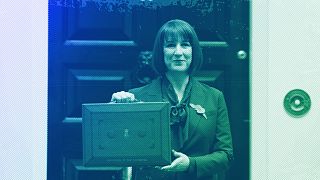 Britain's Chancellor of the Exchequer Rachel Reeves holds up the traditional red ministerial box containing her budget speech in London, October 2024