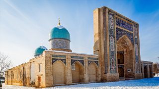 Decorated entrance and two domes of Hazrati Imam complex, religious center of Tashkent, winter time, Uzbekistan