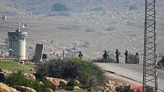 Israeli soldiers stand guard at a checkpoint where the military said an attacker fired at an army base near the village of Tayasir in the northern West Bank, Tuesday, Feb. 4, 