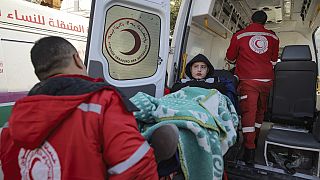 A Palestinian girl wounded in the Israeli bombardment of the Gaza Strip is carried by medics before crossing the Rafah border into Egypt,  in Khan Younis, Saturday Feb. 1, 25