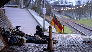 A German national flag waves near a homeless encampment under a bridge, in Frankfurt, Germany. 27 January 2025.