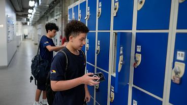 Students store their mobile phones in lockers as they head to class under a new law restricting their use on campus at Porto Seguro School in Sao Paulo, Thursday, Feb. 6, 2025