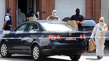 Police and forensic officers remove items during a house search in the Molenbeek district of Brussels on Wednesday, June 21, 2017. 