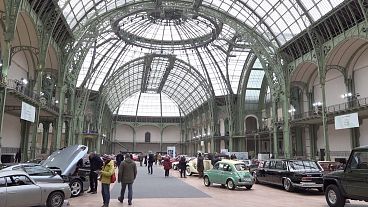 People looking at vintage cars on display at Grand Palais in Paris