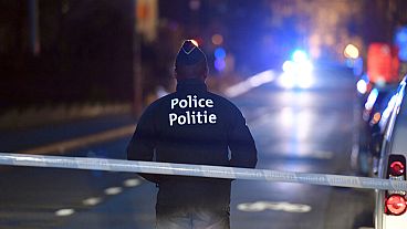 A police officer stands at a cordon during the investigation of a suspect car in the center of Brussels on Thursday, March 2, 2017.