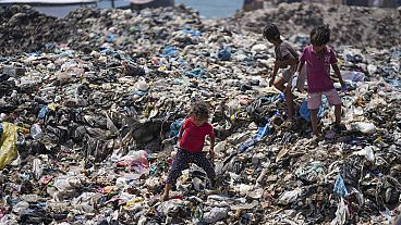 Palestinian kids sort through trash at a landfill in Nuseirat refugee camp, Gaza Strip