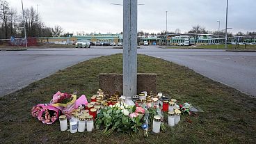 Flowers and candles are placed at a makeshift memorial near the scene of a shooting on the outskirts of Orebro, Sweden, Wednesday, Feb. 5, 2025. 