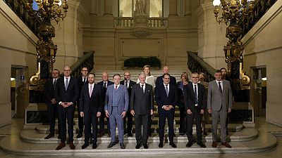 Belgium's King Philippe, center front, and new Belgian Prime Minister Bart De Wever, front center left, pose with ministers.