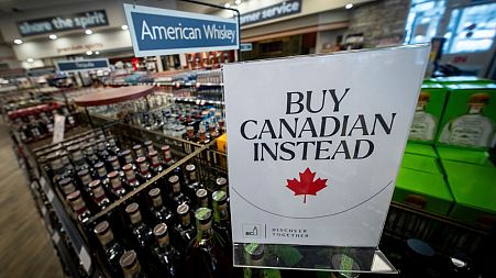 A sign is placed in front of the American whiskey section at a British Columbia liquor store after top selling American made products have been removed from shelves.