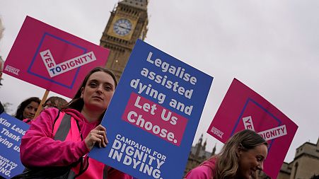 A small demonstration outside the Houses of Parliament by people who are advocating for assisted dying, October 2024.