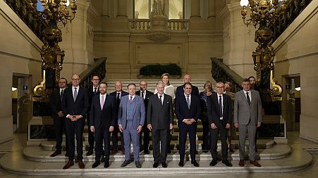 Belgium's King Philippe, center front, and new Belgian Prime Minister Bart De Wever, front center left, pose with ministers.