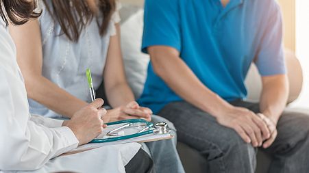 A couple consult with a doctor for fertility treatments.
