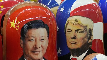 Traditional Matryoshka Russian wooden dolls on sale in Russia last year depict China's President Xi Jinping, left, and US President Donald Trump 