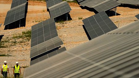 Maintenance engineers check installations at a new solar park outside the northern Greek city of Kozani on Friday, June 3, 2022.