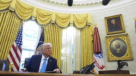 President Donald Trump speaks to reporters after signing executive orders in the Oval Office of the White House